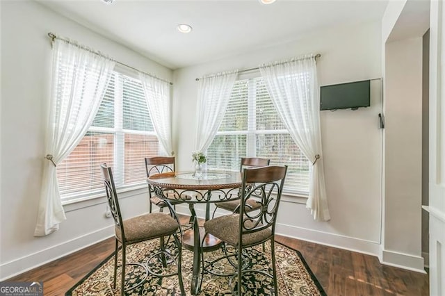 dining area featuring dark wood-type flooring