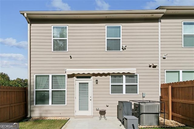 rear view of house featuring a patio and cooling unit