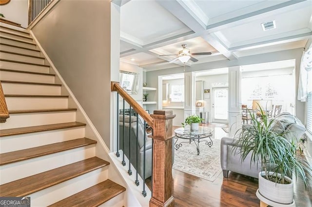 staircase with beam ceiling, ceiling fan, wood-type flooring, decorative columns, and coffered ceiling