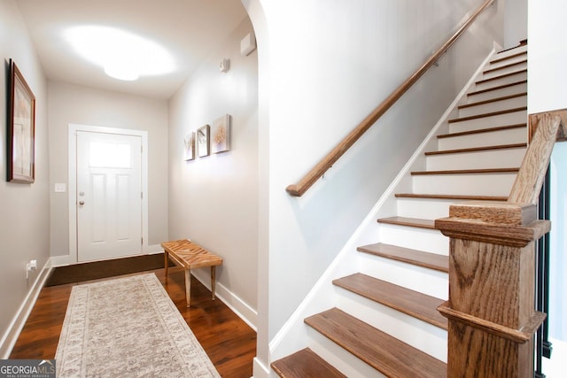 foyer entrance featuring dark wood-type flooring