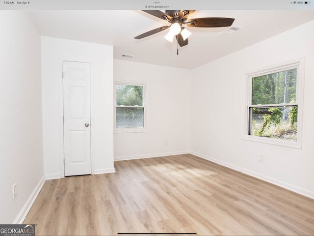 empty room with light hardwood / wood-style flooring, ceiling fan, and plenty of natural light