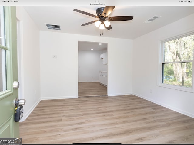 empty room with light hardwood / wood-style floors and ceiling fan