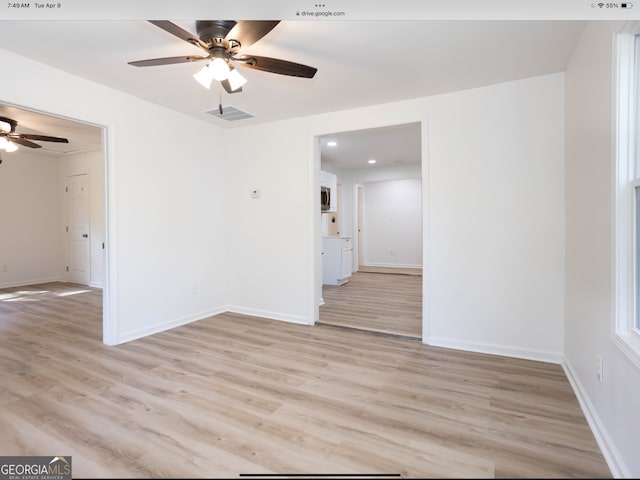 spare room with light hardwood / wood-style floors and ceiling fan