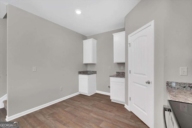 clothes washing area with dark wood-type flooring