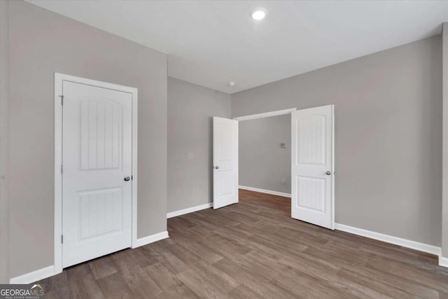 unfurnished bedroom with wood-type flooring