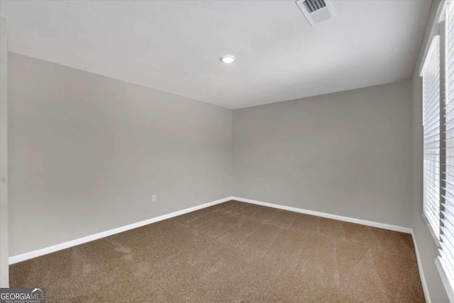 empty room featuring carpet and a healthy amount of sunlight