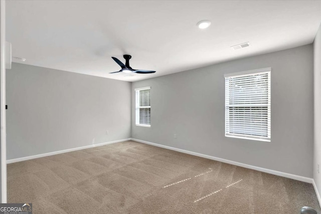 carpeted empty room featuring ceiling fan