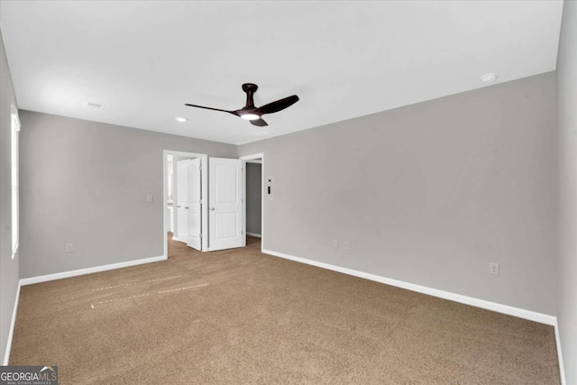 spare room featuring carpet flooring and ceiling fan