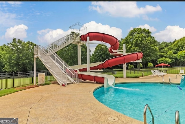 view of swimming pool featuring a water slide