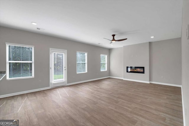 unfurnished living room featuring light hardwood / wood-style floors and ceiling fan