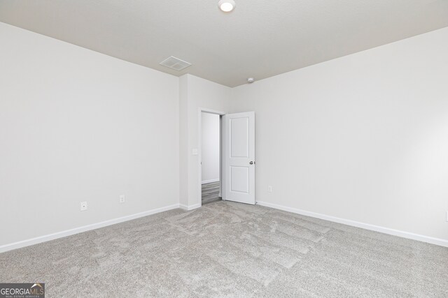 unfurnished room with light colored carpet