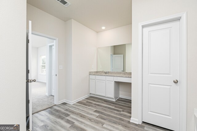 bathroom featuring vanity and hardwood / wood-style floors