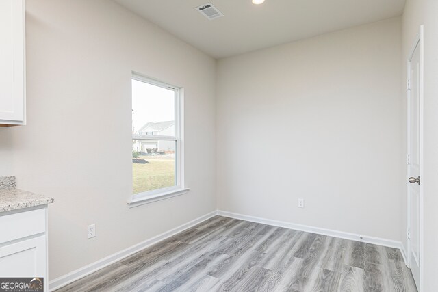 unfurnished dining area with light wood-type flooring