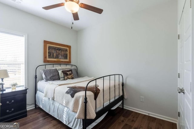 bedroom with ceiling fan and dark hardwood / wood-style flooring