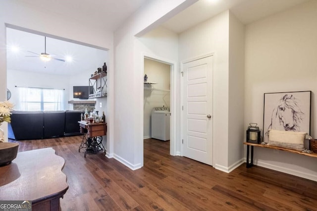 hall with washer / clothes dryer and dark wood-type flooring