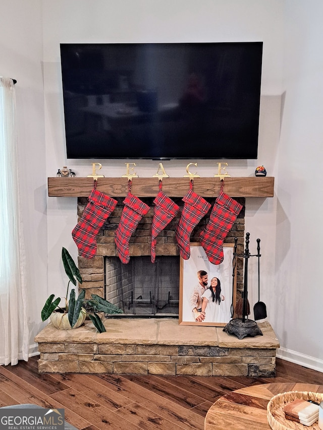 interior details featuring hardwood / wood-style flooring and a fireplace