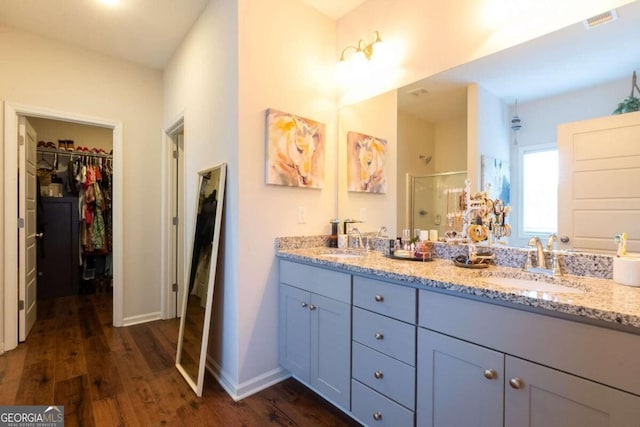 bathroom featuring vanity, a shower with shower door, and hardwood / wood-style flooring