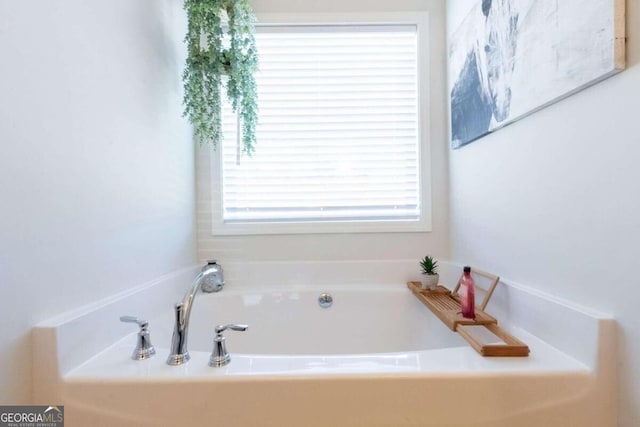 bathroom with a tub to relax in