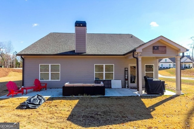 back of house with an outdoor living space, a yard, and a patio