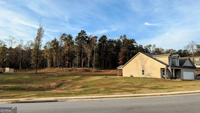 view of side of home with a lawn