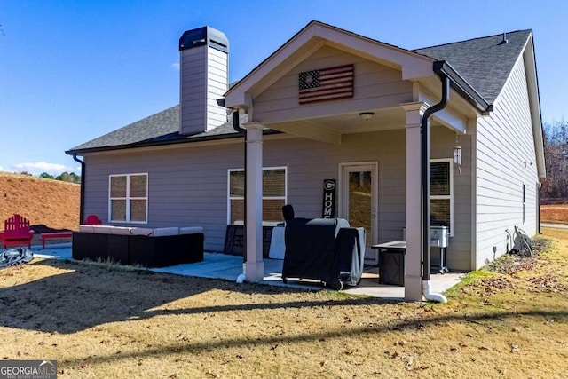 rear view of house featuring a patio area and an outdoor hangout area