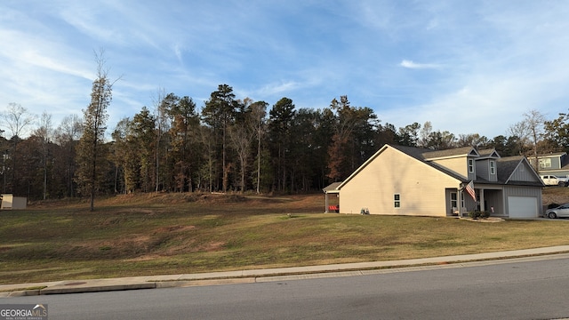 view of home's exterior with a garage and a lawn