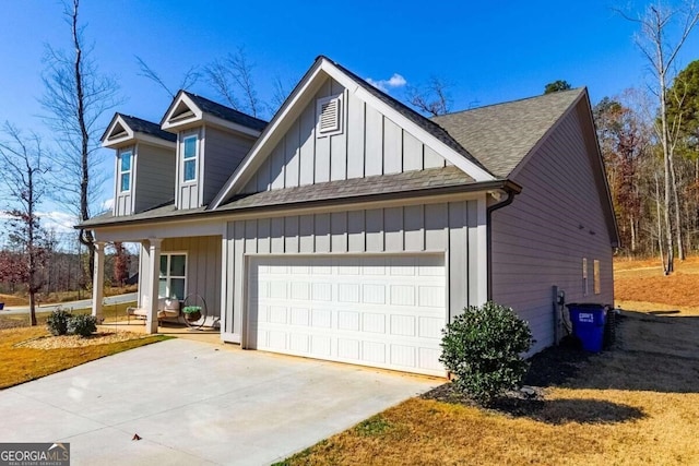 view of side of property with a porch and a garage