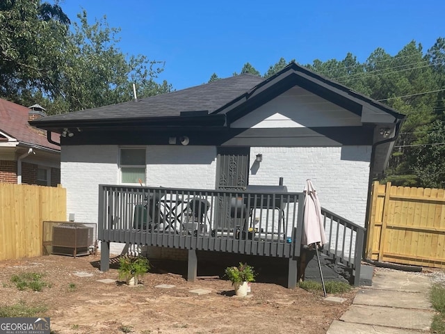 rear view of house featuring central AC and a deck