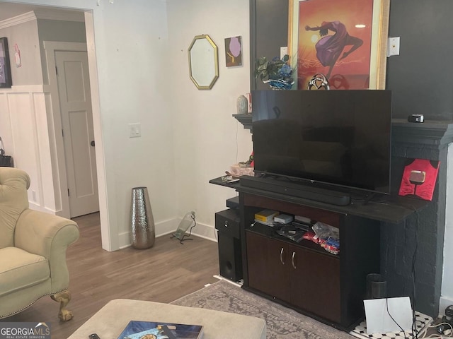 living room with hardwood / wood-style flooring and ornamental molding