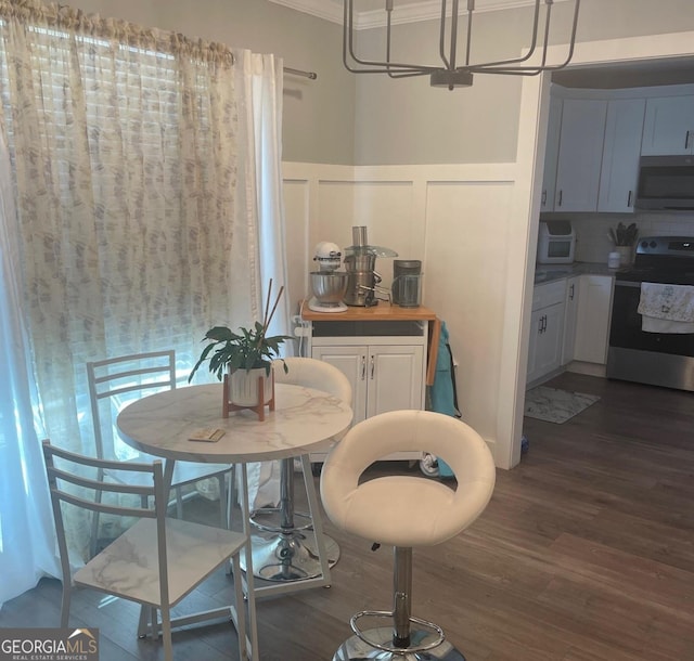 dining area with crown molding and dark hardwood / wood-style floors