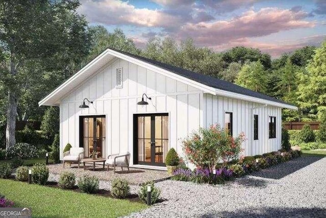 back house at dusk featuring french doors