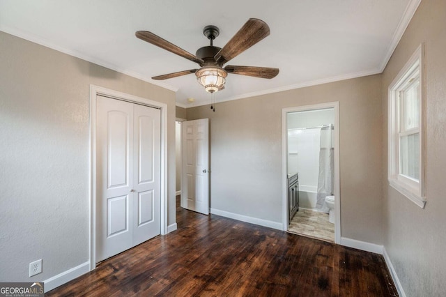 unfurnished bedroom featuring dark wood-type flooring, ceiling fan, a closet, and ornamental molding