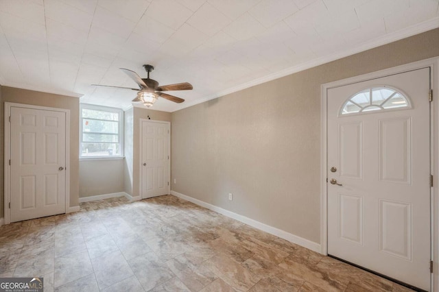 entryway featuring crown molding, plenty of natural light, and ceiling fan