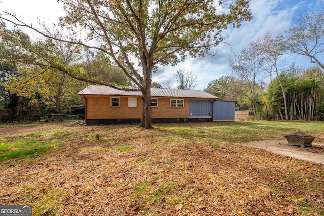 back of property with a fire pit