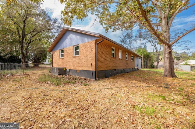 view of side of home with central AC unit