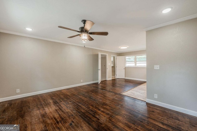 empty room featuring ornamental molding, dark wood-type flooring, and ceiling fan