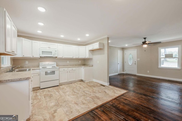 kitchen with crown molding, sink, light wood-type flooring, white cabinets, and white appliances