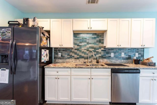 kitchen with white cabinetry, sink, stainless steel dishwasher, and refrigerator with ice dispenser