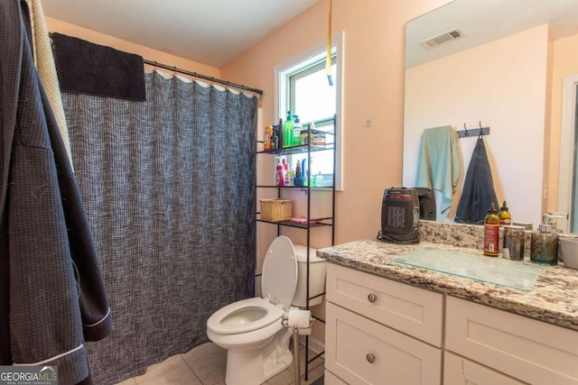 bathroom featuring vanity, toilet, and tile patterned floors