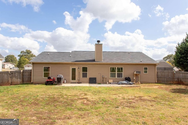 rear view of house featuring a patio area and a lawn