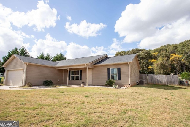 ranch-style home featuring central air condition unit, a front lawn, and a garage