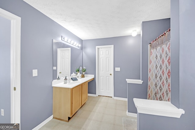 bathroom with vanity and a textured ceiling