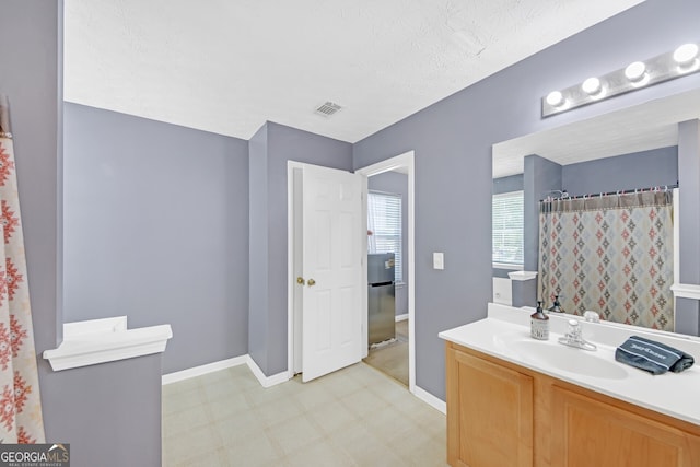 bathroom featuring vanity and a textured ceiling