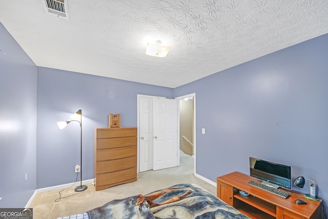 carpeted bedroom featuring a textured ceiling