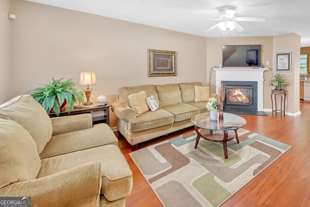 living room with hardwood / wood-style floors and ceiling fan