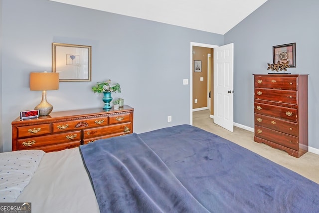 bedroom with light carpet and vaulted ceiling