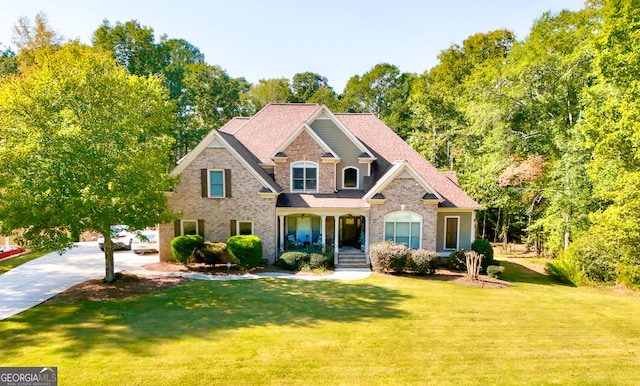 view of front of home with a front yard and a porch