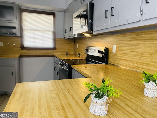 kitchen featuring appliances with stainless steel finishes, backsplash, and gray cabinetry