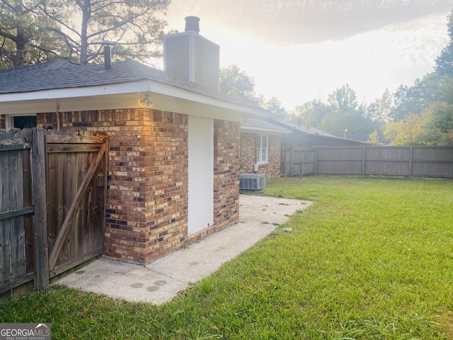 exterior space featuring central AC and fence