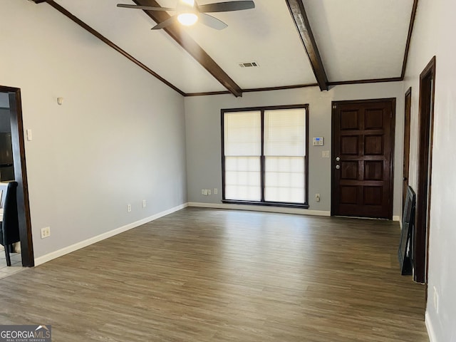 interior space with lofted ceiling with beams, dark wood-style flooring, a ceiling fan, visible vents, and baseboards